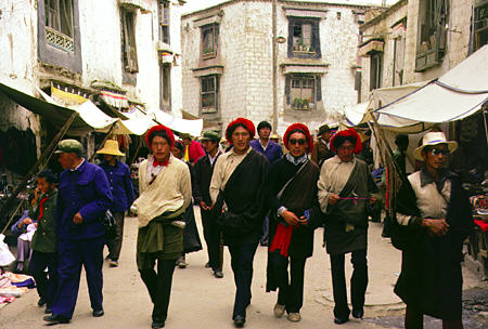 Men in hats form some of the street life in Lhasa, Tibet. China.