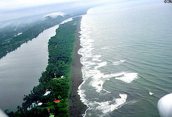 Coast seen from air on plane to Tortuguero National Park with airstrip on tip of barrier island. Costa Rica.