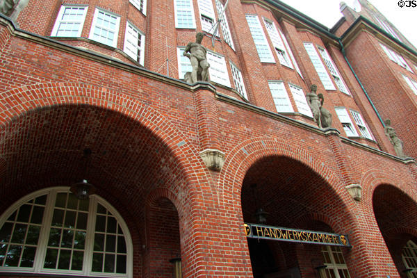 Statues above entrance to Handwerkskammer building. Hamburg, Germany.