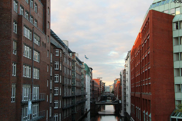 Buildings facing each other over one of Hamburg's narrow canals in old town aka Speicherstadt district. Hamburg, Germany.