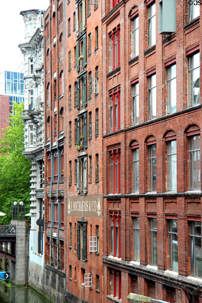 Facades of former commercial buildings (now often residences) along canal. Hamburg, Germany.