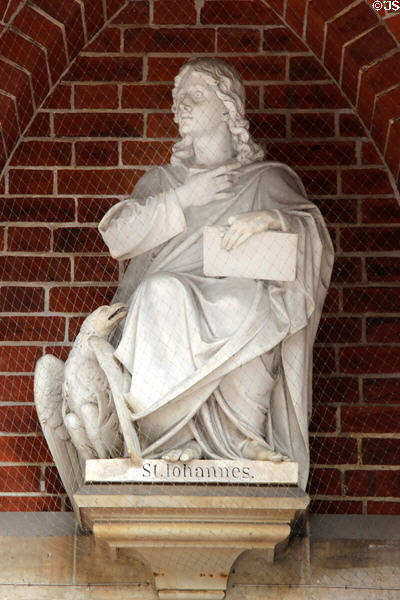 Statue of Evangelist, St John, with his attribute eagle, at entrance to St Peter's Church. Hamburg, Germany.
