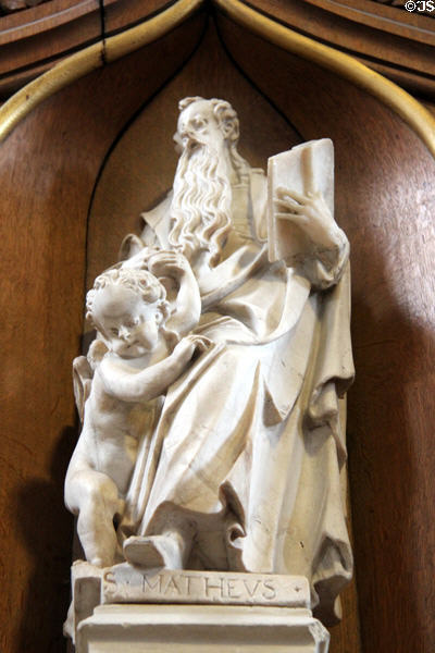 Statue of Evangelist, St Matthew, with his attribute angel on pulpit in St Peter's Church. Hamburg, Germany.