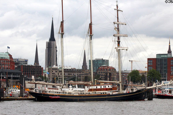 Morgenster, a 48m, two masted tall ship (1919) profiled against city. Hamburg, Germany.