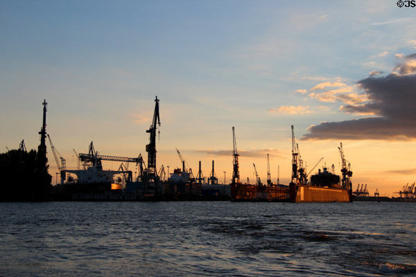 Dockyards along Elbe River seen at sunset. Hamburg, Germany.