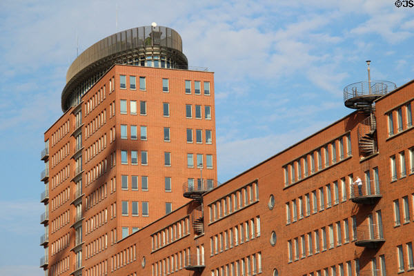 Modern brick & glass office building across canal from Elbphilharmonie in HafenCity. Hamburg, Germany.