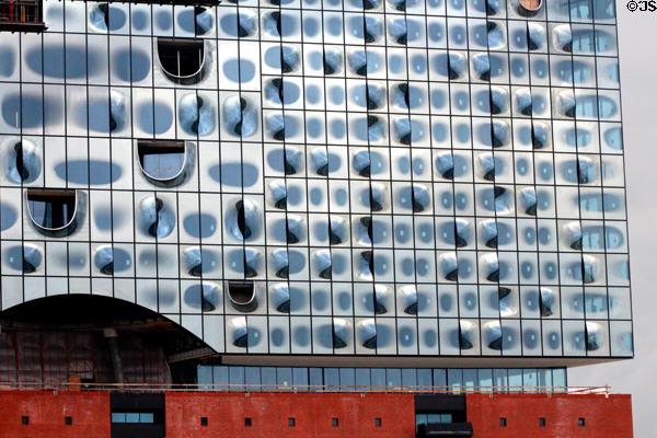 Glass facade of Elbphilharmonie concert hall (2017) on Grasbrook Peninsula of Elbe River in HafenCity. Hamburg, Germany.