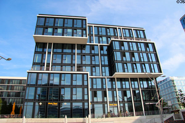 Front facade with shops of three level black glass building (Am Kaiserkai 1 & Grosser Grasbrook 12) in HafenCity. Hamburg, Germany.