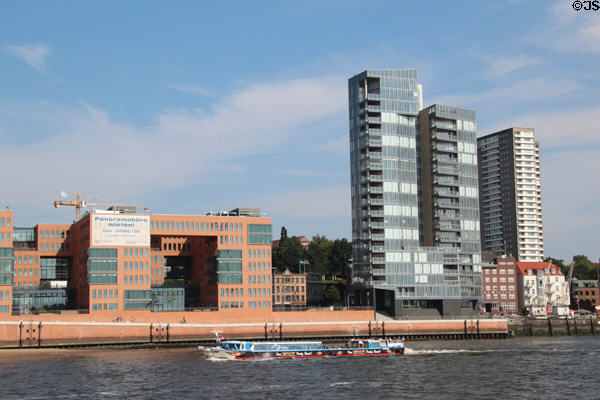 Tourist boat sailing past modern buildings in Altona borough. Hamburg, Germany.