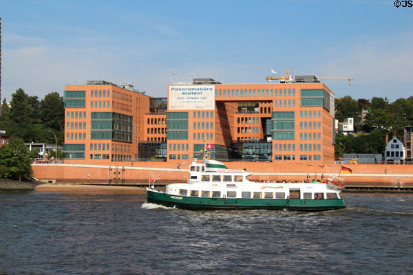 Tourist boat sailing past modern office building in Altona borough. Hamburg, Germany.