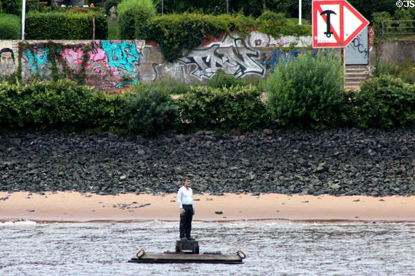 Buoy-men, floating statue of man on raft in Elbe River by Stephan Balkenhol at Altona borough. Hamburg, Germany.