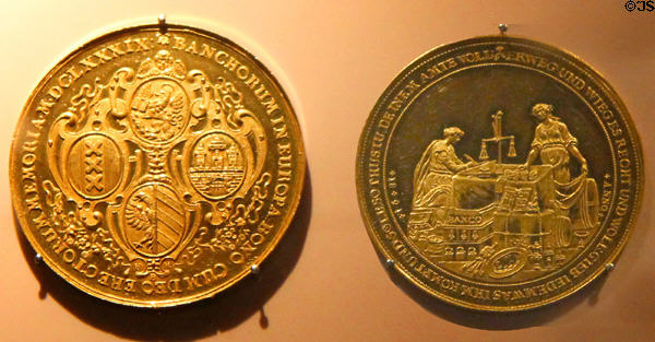 Gold coins from Portuguese Bank: left engraved with symbols of four banking cities Venice, Amsterdam, Nürnberg & Hamburg (1665) & right engraved with Hamburg bank (1681) at Hamburg History Museum. Hamburg, Germany.