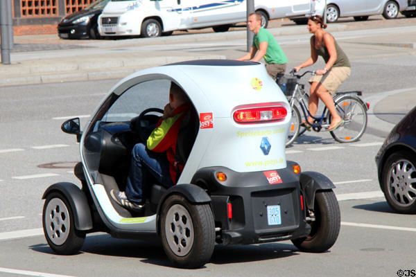 Mini-car traveling on city streets. Hamburg, Germany.