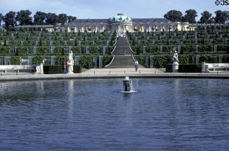 Overview of Sanssouci Palace above trellised grape vines & reflecting pool. Potsdam, Germany.