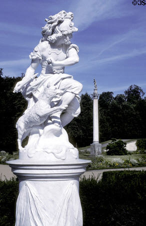 Classical-style sculpture of greek helmeted god with dog in Sanssouci garden. Potsdam, Germany.