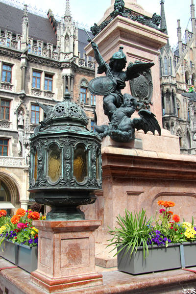 Lantern & St. Michael slaying Dragon on base of Marien column at Neues Rathaus. Munich, Germany.