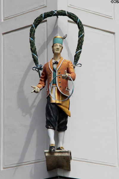 Oktoberfest celebrant statue with arch of hops on corner of Marienhof. Munich, Germany.