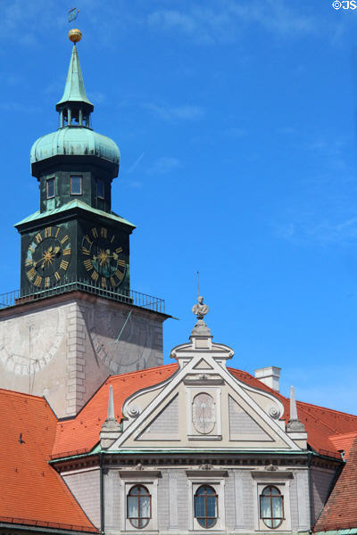 Clock tower with sundial over Baroque roofline in Brunnenhof courtyard at Munich Residenz. Munich, Germany.