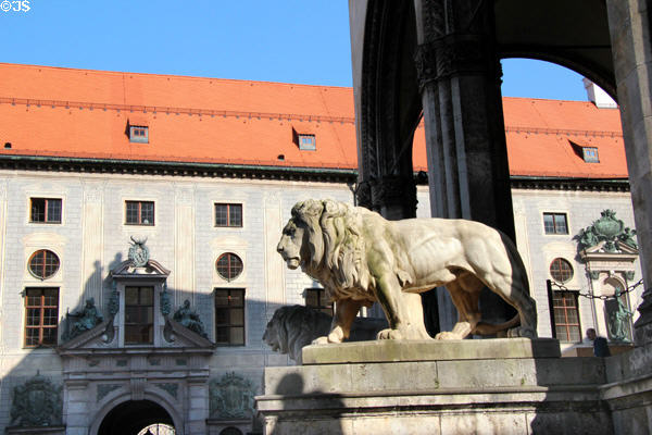 Lion sculpture (1844) at Feldherrnhalle with Munich Residenz beyond. Munich, Germany.