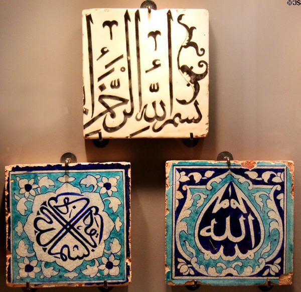 Muslim inscribed ceramic tiles, white from Syria (16th-17thC) & blue from Pakistan (18th-19thC) at Five Continents Museum. Munich, Germany.