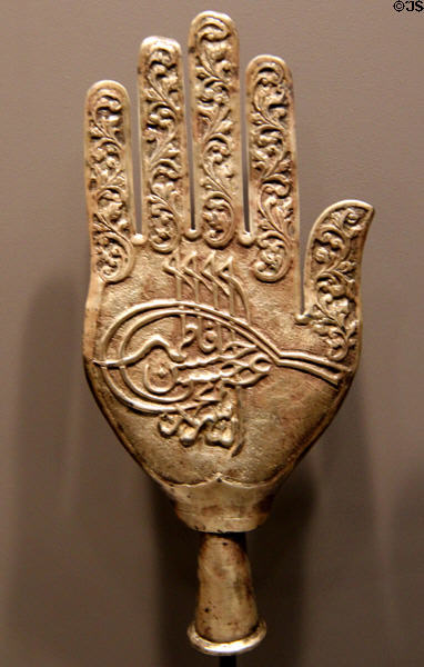 Muslim metal finial in shape of hand with calligraphy (early 20thC) from Karachi, Pakistan at Five Continents Museum. Munich, Germany.