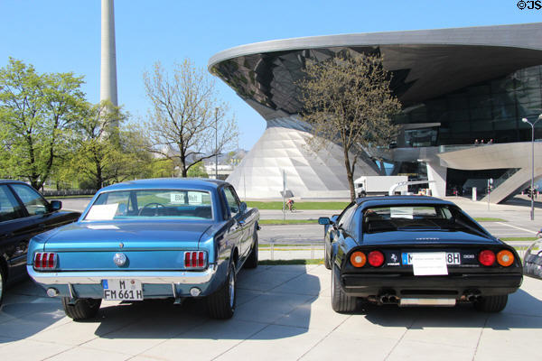 Ford Mustang & Ferrari at BMW Museum with BMW World beyond. Munich, Germany.