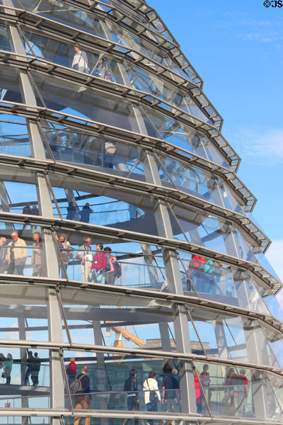 Visitors walk spiral within German Bundestag dome. Berlin, Germany.