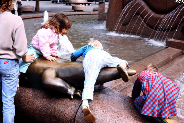 Children play on Europa Centre Fountain. Berlin, Germany.