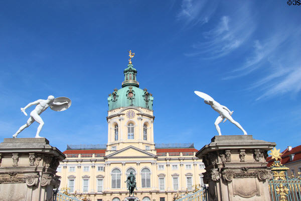 Sculpted Greek warriors with swords & shields face off from atop fence pillars flanking Charlottenberg Palace. Berlin, Germany.