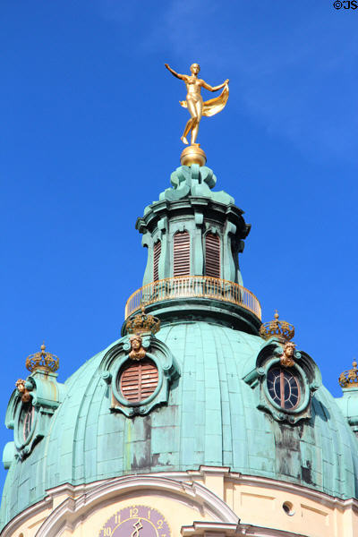 Golden statue atop baroque tower dome at Charlottenberg Palace. Berlin, Germany.