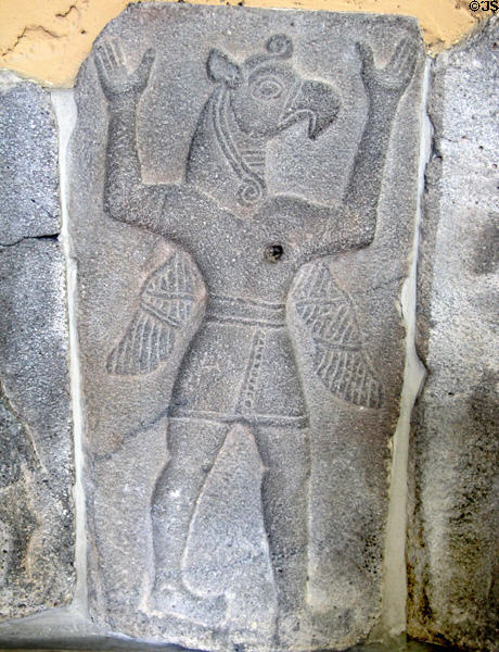 Assyrian relief of winged human body with bird head in transition between to more human form at Pergamon Museum. Berlin, Germany.