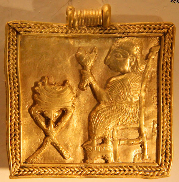 Gold pendent with scene of a funeral supper (9th-7thC BCE) from iron age Syria at Pergamon Museum. Berlin, Germany.