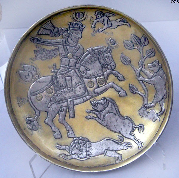Partially gilded silver platter with scene of Sasanian king on horseback hunting lion, boar & bear (7thC) from Iran at Pergamon Museum. Berlin, Germany.