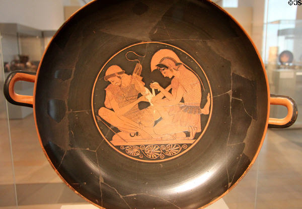Greek terracotta red figure Kylix (wine cup) (c500 BCE) from Vulci, Italy shows Achilles binding Patroclus at Altes Museum. Berlin, Germany.