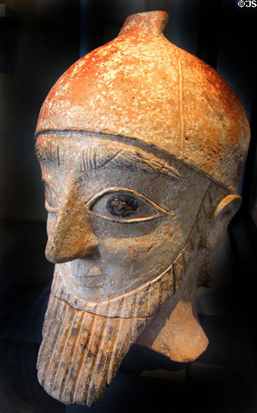 Terra-cotta head of male statue with conical helmet painted red & black (7th-6thC BCE) from Nicosia, Cyprus at Neues Museum. Berlin, Germany.