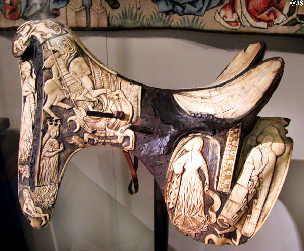 Saddle (c1440) with engraved ivory scenes including image of St George slaying the dragon at German Historical Museum. Berlin, Germany.