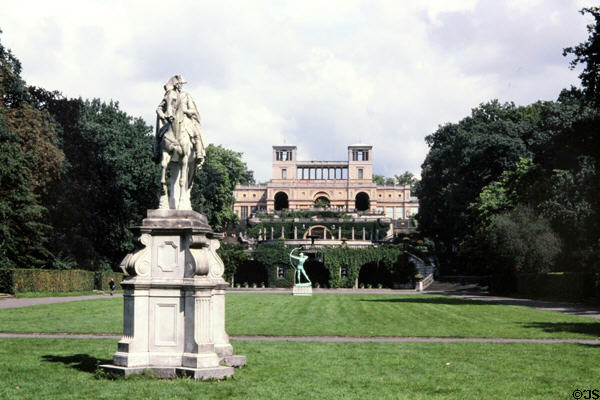 Orangery Palace (1864) beyond sculptures at Sanssouci Park. Potsdam, Germany.