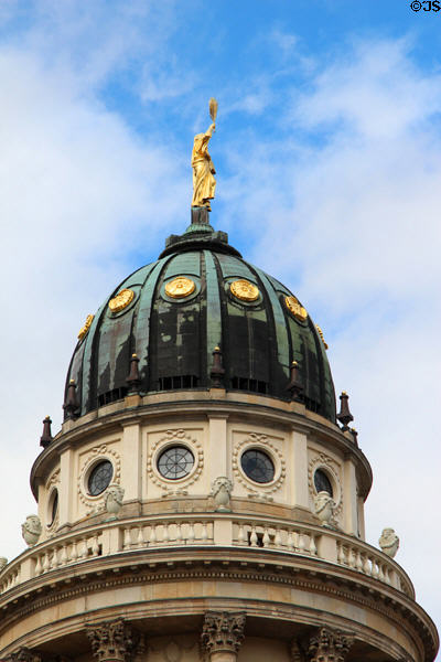 Dome with gilded figure holding palm frond atop French Cathedral of Berlin. Berlin, Germany.