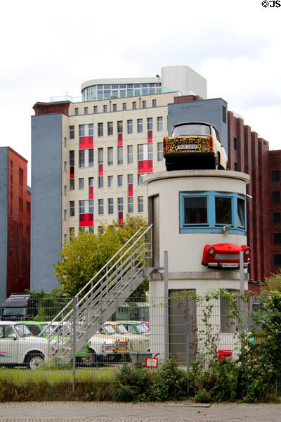 Tourist display of Trabant cars around former Berlin Wall watchtower in Berlin Mitte. Berlin, Germany.
