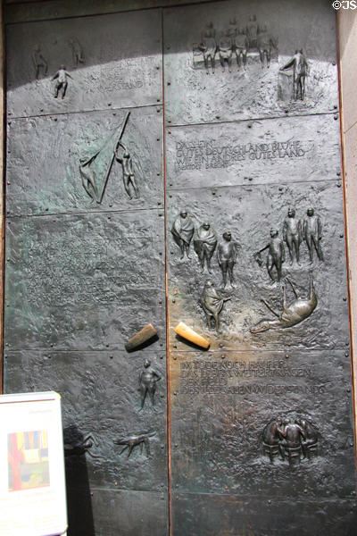 Greifswald Town Hall bronze doors (1965) by Joachim Jastram documents saving of town through 1945 surrender to Soviet troops. Greifswald, Germany.