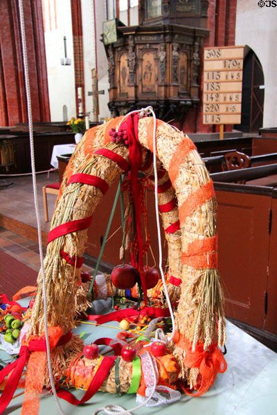 German harvest festival wreath (Erntedánkfest) wreath at St. Mary's Church. Greifswald, Germany.