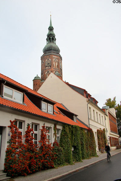 Streetscape with St. Nicholas Church tower. Greifswald, Germany.