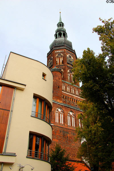Art Moderne residence with St Nicholas Church tower. Greifswald, Germany.