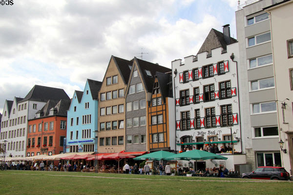 Outdoor dining and colorful buildings in restored Fischmarkt area along the Rhine River waterfront. Köln, Germany.