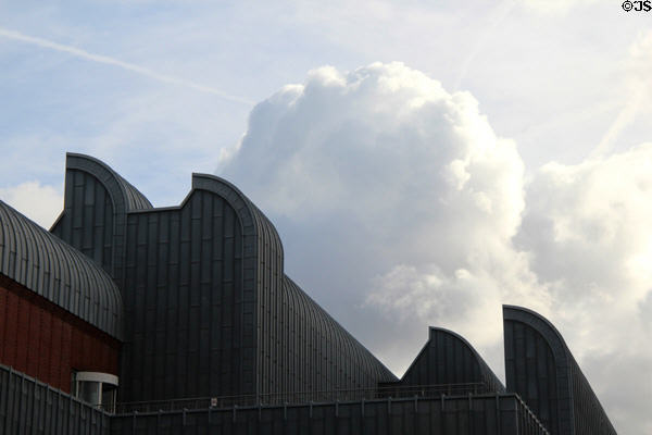 Distinctive roof line against cumulus clouds at Ludwig Museum. Köln, Germany.