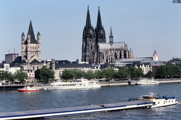 Skyline from Deutzer Bridge over Rhine with towers of Gross St Martin church & Cologne Cathedral. Köln, Germany.