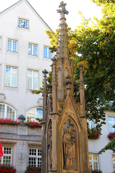 Vinzenbrunnen fountain on Munsterplatz in front of Cathedral with statues of Virgin Mary, St Vincent de Paul, Archangel Michael & St Foillan. Aachen, Germany.
