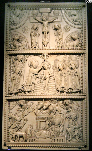 Ivory relief panel with Jesus' birth, baptism in the River Jordan & crucifixion of Christ (c1100) at Aachen Cathedral Treasury. Aachen, Germany.