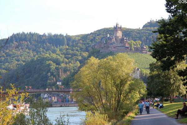 Imperial Castle overlooking promenade along Mosel River. Cochem, Germany.