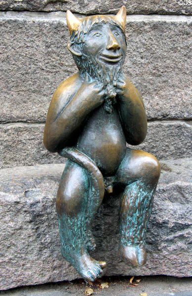 Devil's figure sculpted in bronze sitting on Devil's Stone (1999) by Rolf Goerler Bildhauer at St Mary's Church. Lübeck, Germany.